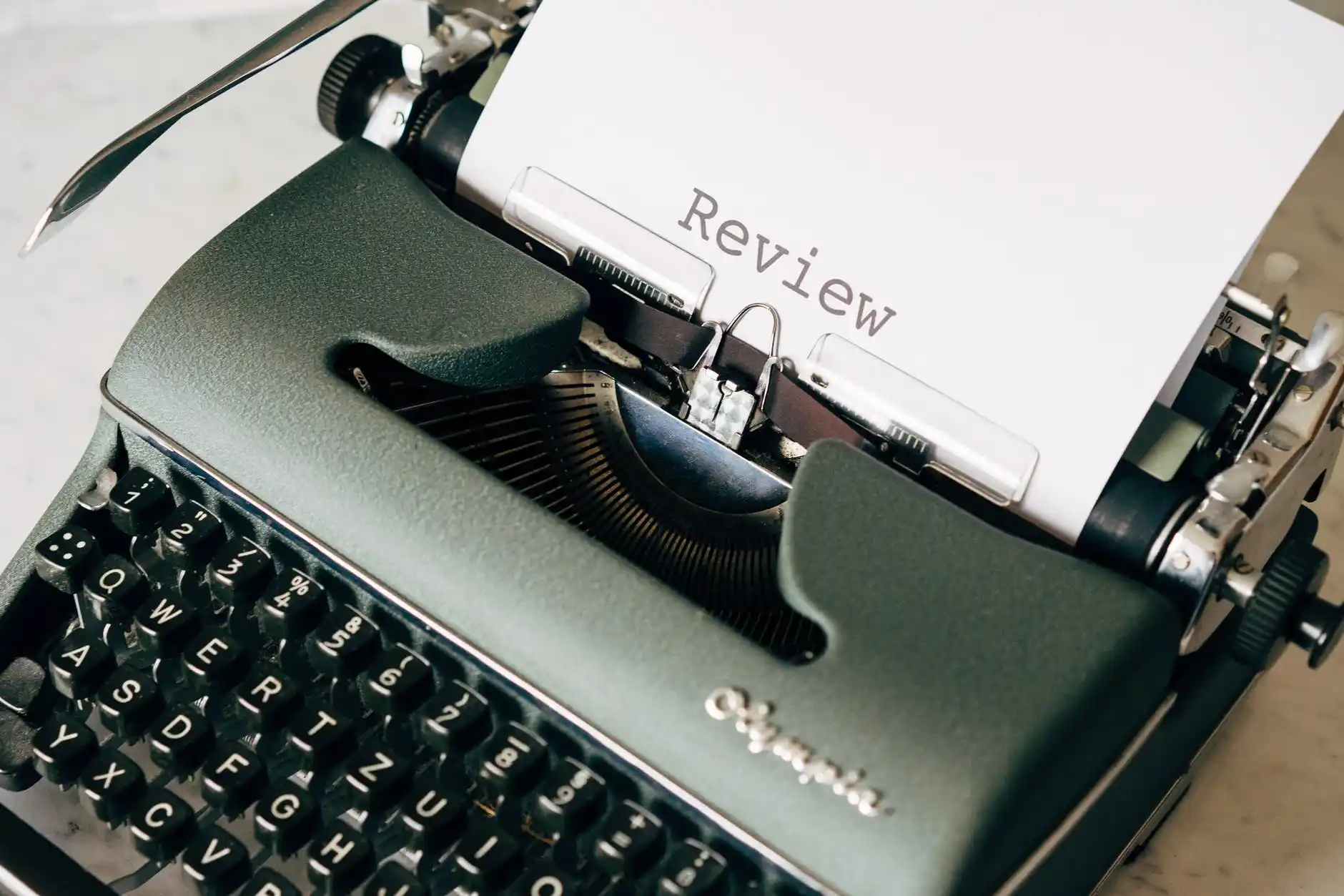 typewriter with the word review typed on the page